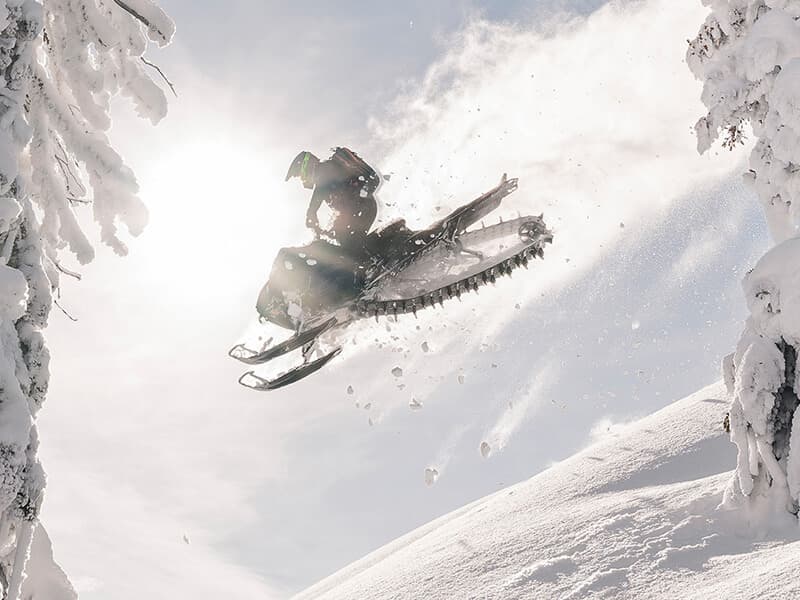 Arctic Cat snowmobile in deep powder